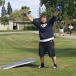 ASYC VP, Paul Cluck ,raises his arms in victory while doin a bean bag toss