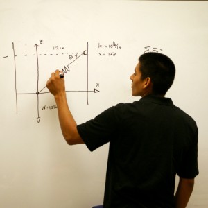 Christian Ruiz is demonstrating an equation | Photo by: Robert Angus