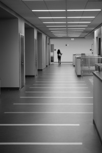A student strolling through an empty hallway.