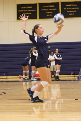 Allison Foster as she throws up a serve against Southwestern Oregon Community College | Photo by Alexis Pack