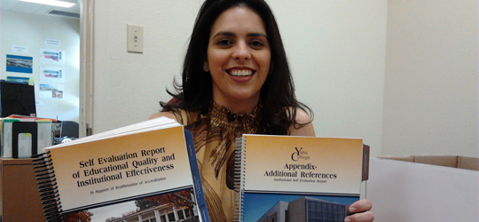 Anabel Toche displays the completed accreditation reports | Photo by Francesca Hulin