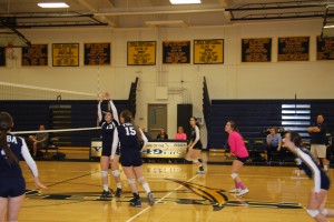 Kylee Sallaberrey and Amgela Dehaan converge at the net in a game against Contra Costa