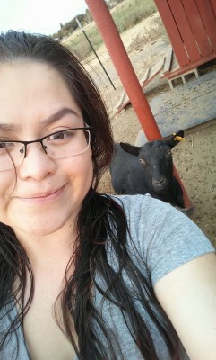 Ana on farm duty with a goat. (Photo courtesy of Ana Martinez.)