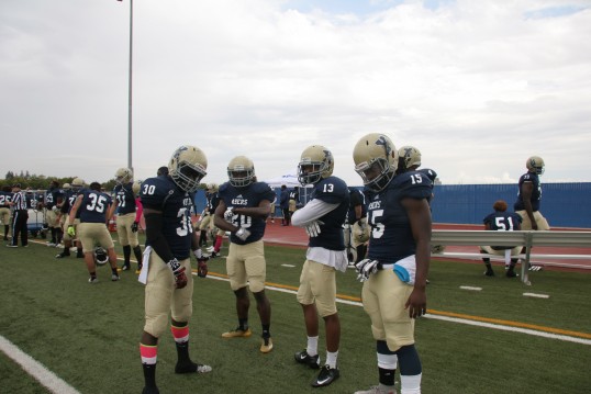 Yuba College players clowning on the sideline. Pictured from left to right are Kevin Brunner, Devontee McNamee, Isaiah Francis, and Chedson Jean