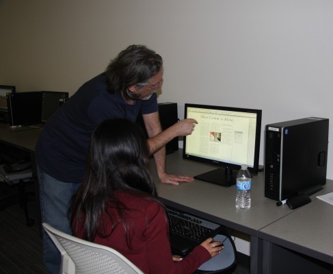 Mass Communications 20 adviser Greg Kemble and student Regina Hernandez work on the newspaper.