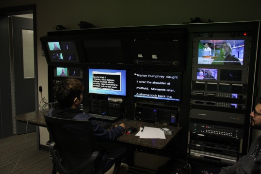 A student works the teleprompter for a Mass Communications 4 class.