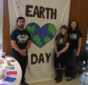 Martin Flores, Brielle, West, and Tea McGinnis work at the ASYC Earth Day display.