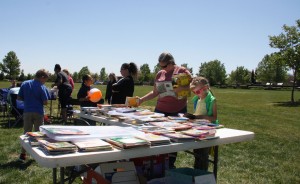 Parents and children browse a variety of books donated by The Psychology Club at the "Planting A Seed For Children's Growth" event at the POW/MIA Edgewater park.