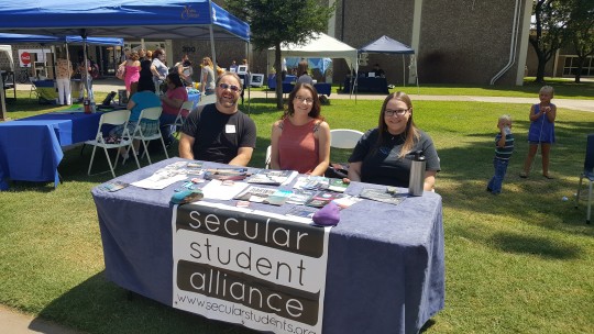 Secular Student Alliance students sit at the club table.