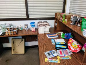 A desk with baby products and school supplies.