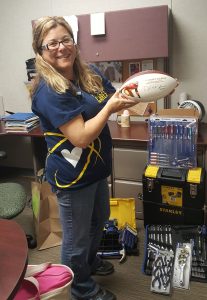 Tammy Pack shows off an autographed football donated for the auction.