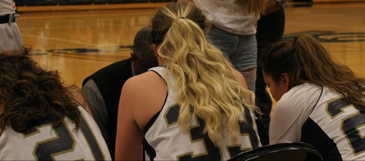Jessica Taylor number 33 listens to Coach Welch in the huddle