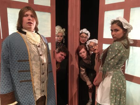 Right to Left: Reid Mertes, Laurel Capps, Grant Myers, Reily Morris-Hagen, Alexis Gaud, and Elizabeth Sutton pose for shot on stage.