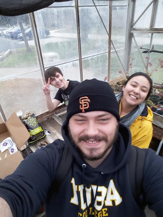 Three people planting seeds for Green Futures.